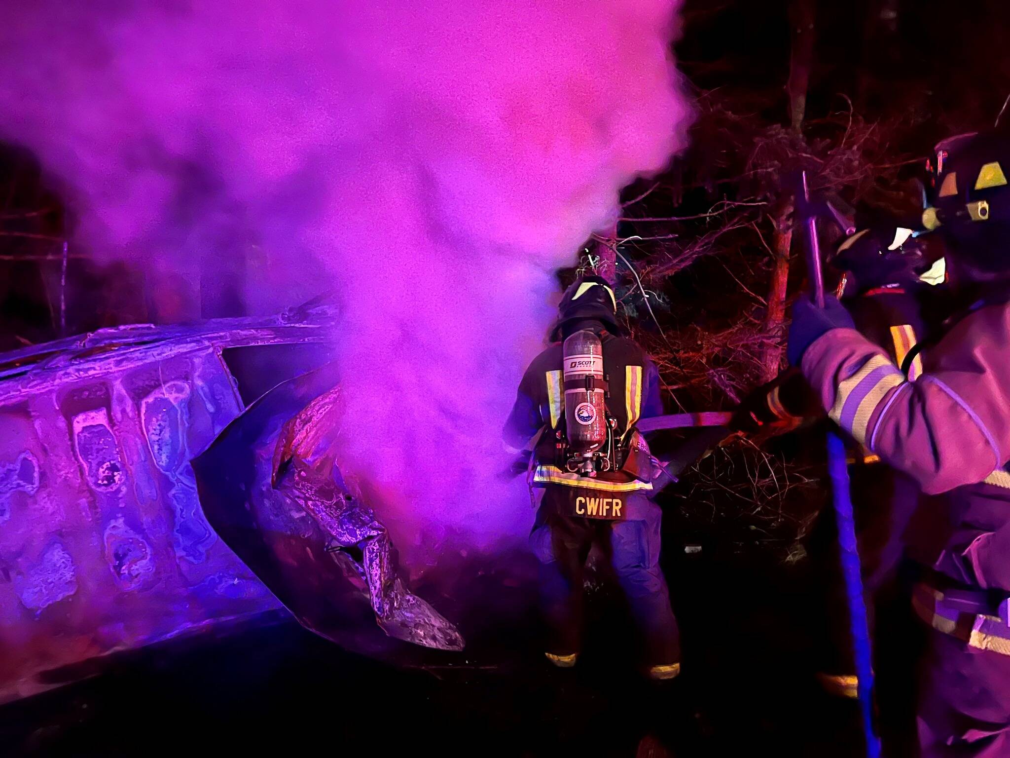 North and Central Whidbey firefighters work to subdue an early morning car fire Dec. 17 between Oak Harbor and Coupeville. (Photo provided)