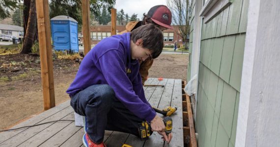 Photo provided
Masyn Eberhardy and Jack Rafferty from Oak Harbor build a deck for one of the tiny homes in Langley.