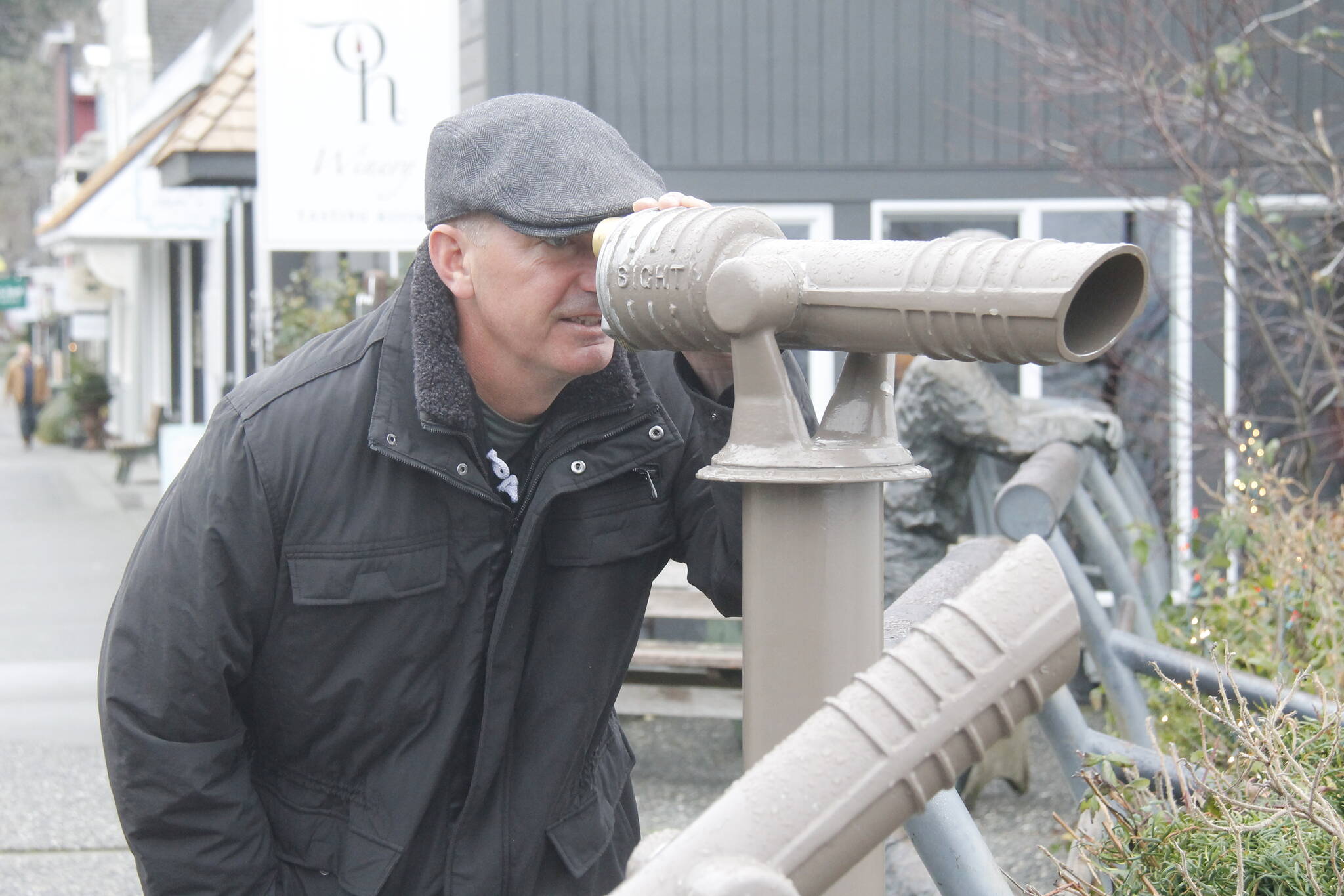 Photo by Kira Erickson/South Whidbey Record
Callahan McVay peers through a telescope on First Street in Langley. During the pandemic, the Langley Main Street Association installed the telescopes, which make for great whale-watching opportunities.