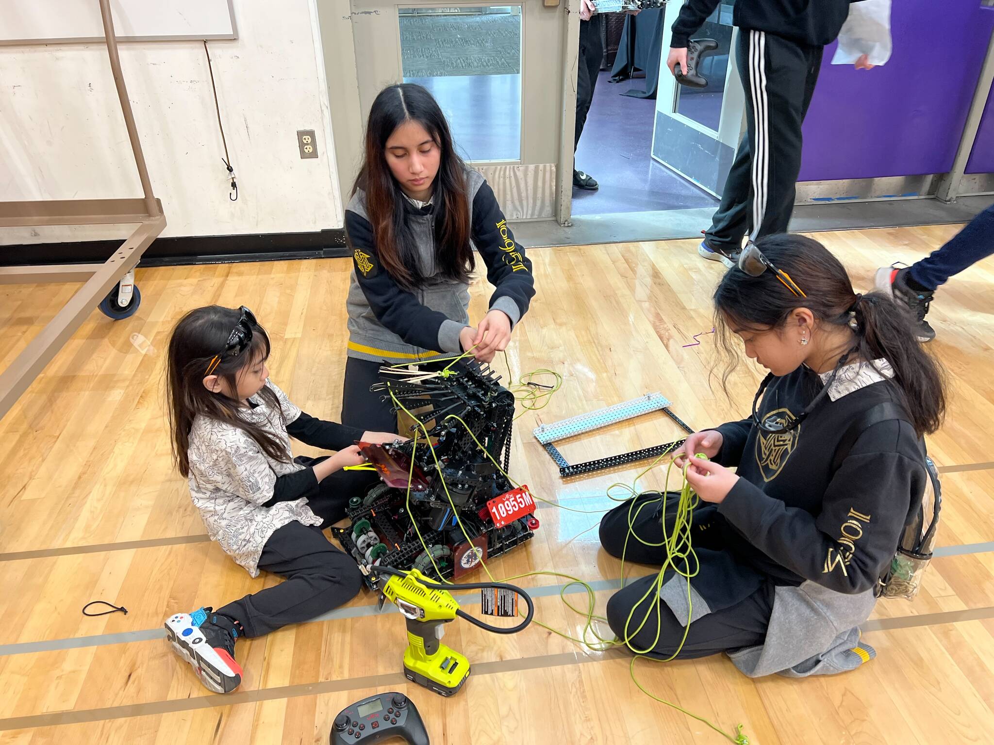 Photo provided
From left, Mikoilo, Mikayla and Misaella Serrantes work on a robot together.