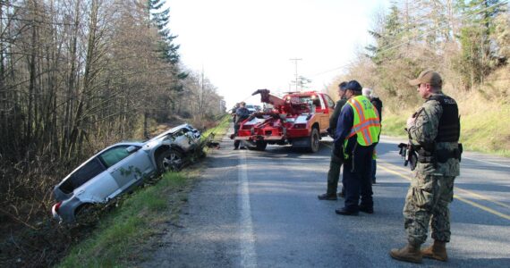 Photo by Luisa Loi
Last Friday, a vehicle rolled down the side of the road and fell about 30 feet onto a dirt road by East Crescent Harbor Road on North Whidbey. The driver was uninjured.
Photo by Luisa Loi
A tow truck pulled out an SUV from the dirt road at the bottom of a 30-foot drop following an accident at East Crescent Harbor Road last Friday.