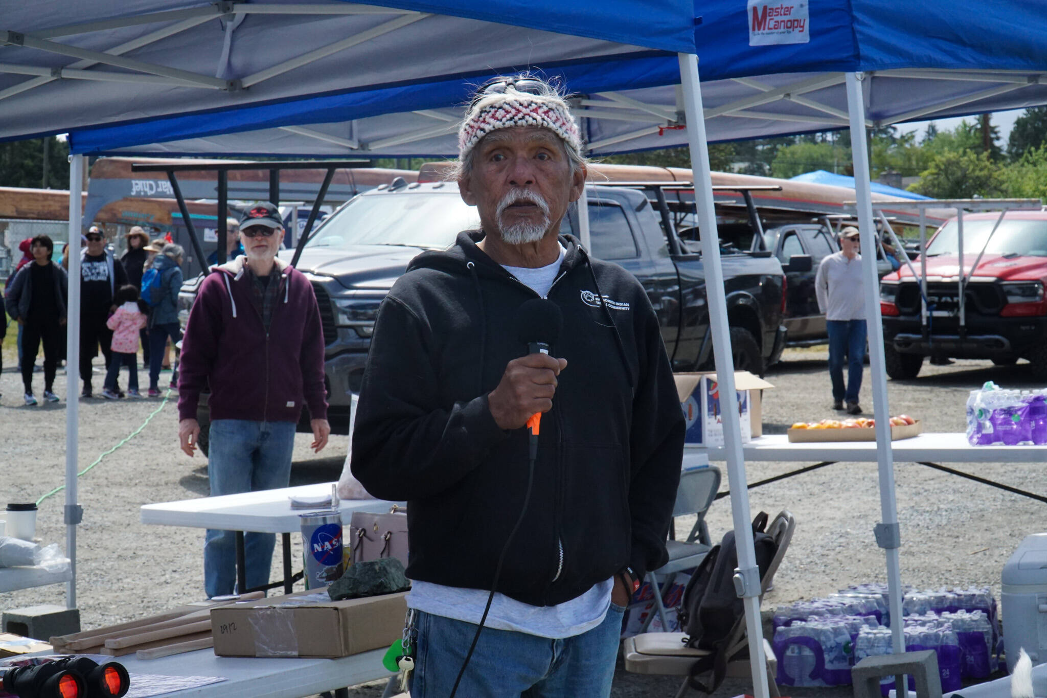 Photo by Sam Fletcher
Tony Cladusbid, co-owner of the Beaver Tales Coffee franchise, announces the canoe racing at the Penn Cove Water Festival on Saturday.