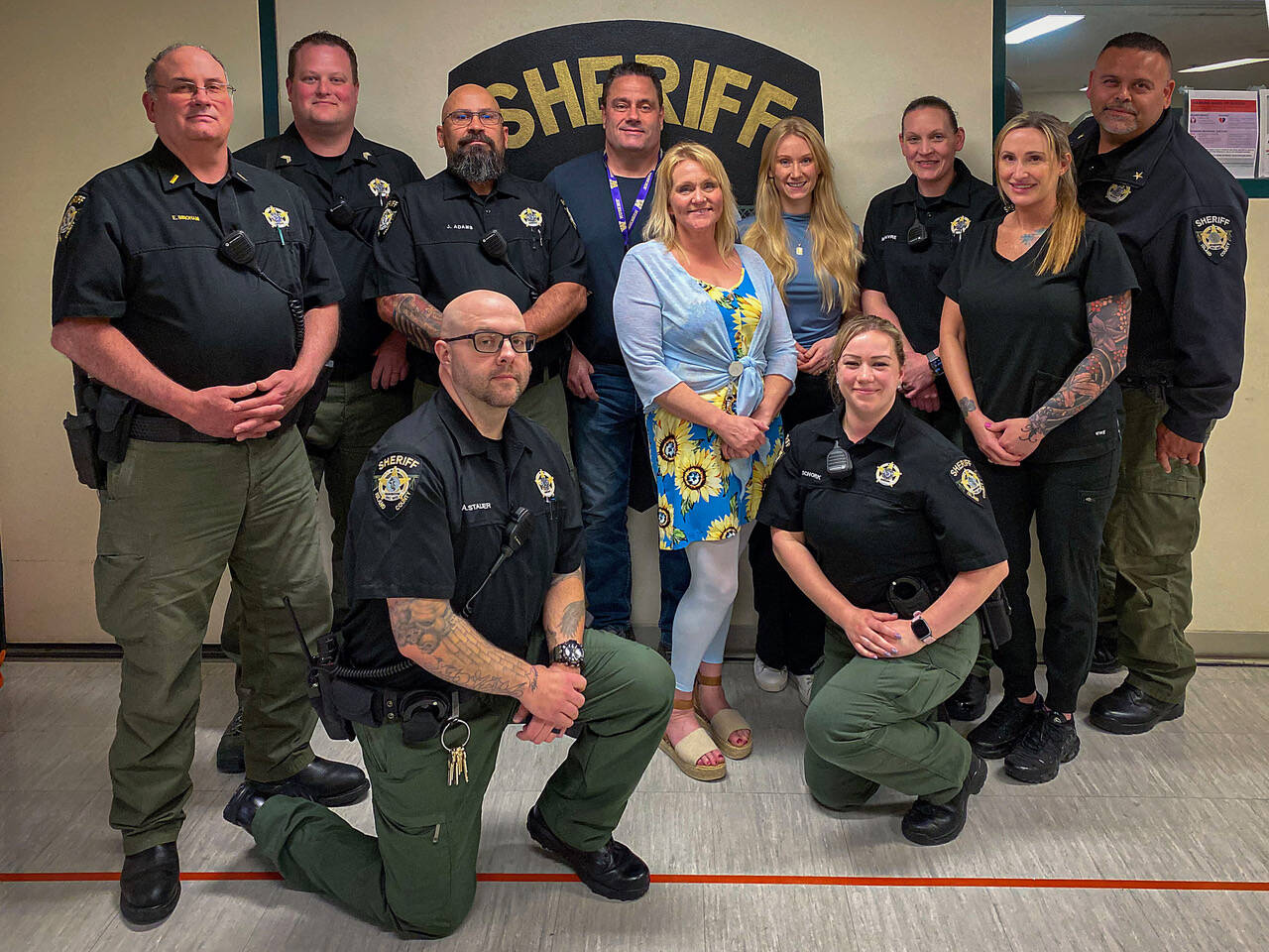 Photo by David Welton
From left, in the back row are Lt. Eric Bingham, Sgt. Tyler Melnick, Deputy Gerald Adams, Transitions Release Coordinator Leif Haugen, Substance Use Disorder Counselor Chelcee Lindell, Mental Health Professional Laurel Brown, Deputy Melissa Faivre, RN Jennifer Horn and Jose Briones. Kneeling in front are Deputy Adam Stalker and Deputy Katherine Schork.