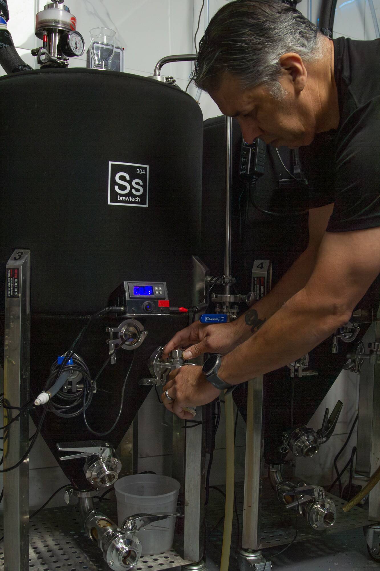 Stephen Chavez, owner of Crossed Arrows Brewery (CAB), pours a sample of his beer. (Photo by Caitlyn Anderson)