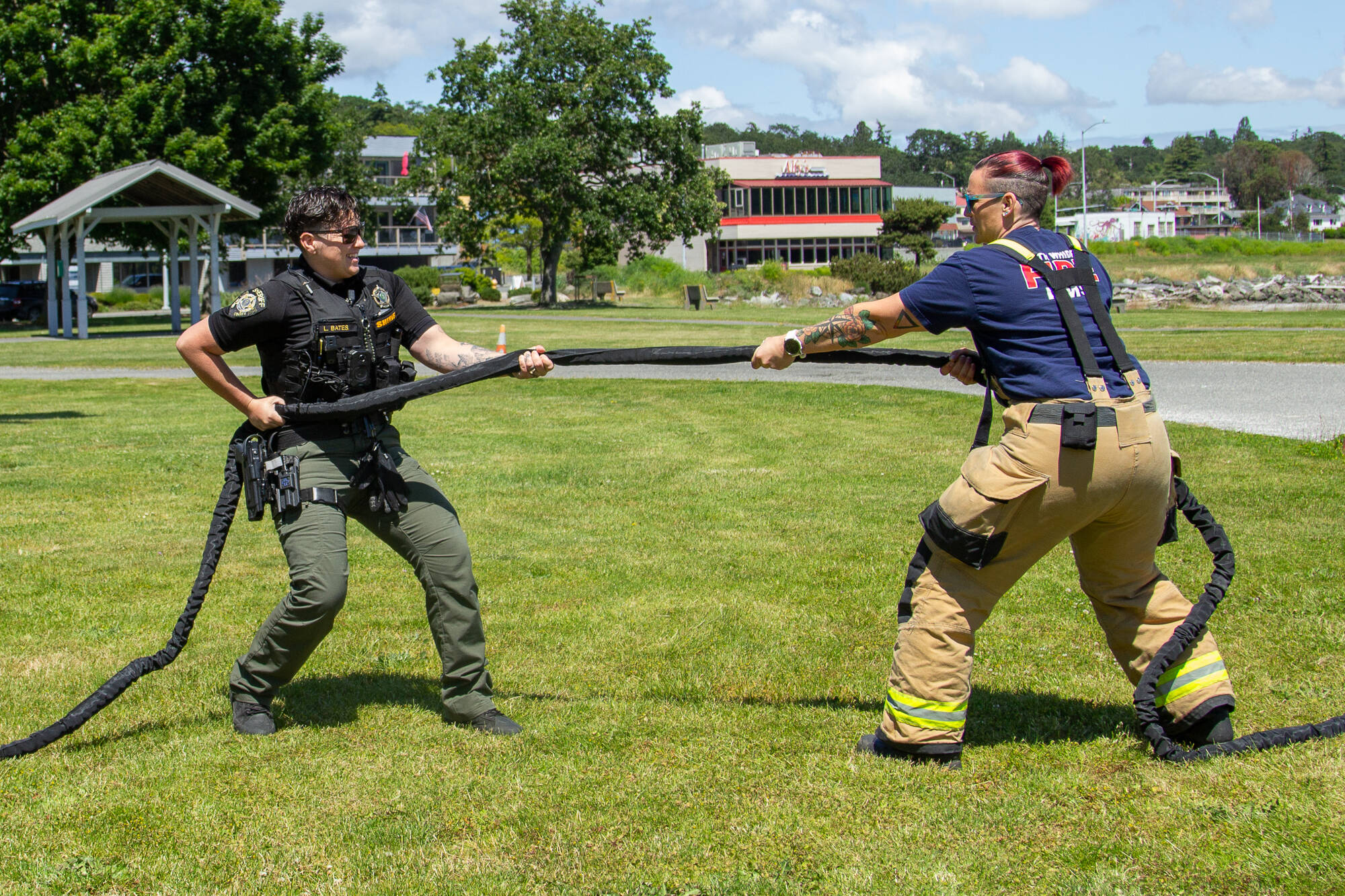 Photo by Caitlyn Anderson
Deputy Sheriff Laurrin Bates (left) and Firefighter Kat Crowe (right) play tug of war in anticipation of the police and firefighter 5k run and tug of war competition, June 12.