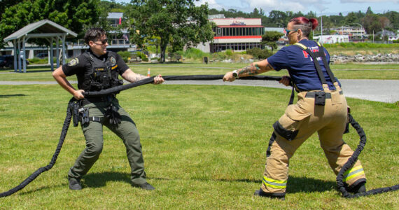 Deputy Sheriff Laurrin Bates (left) and Firefighter Kat Crowe (right) play tug of war in anticipation of the police and firefighter 5k run and tug of war competition, June 12. (Photo by Caitlyn Anderson)