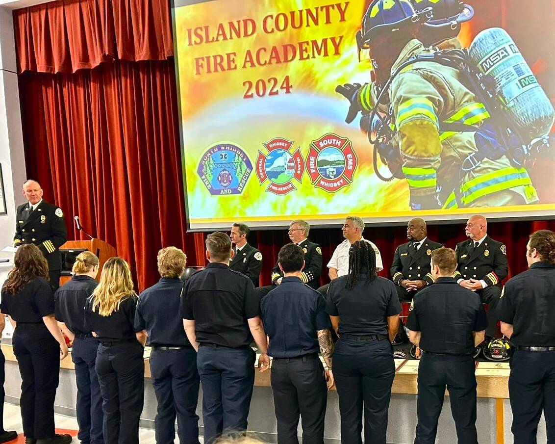 Division Chief Chris Geiger administers the Firefighters Oath to graduates of the 2024 Island County Fire Academy at a ceremony June 11 at Coupeville High School.