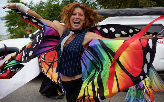 Photo by David Welton
A parade participant from Meander Dance Collective dances down the street at t