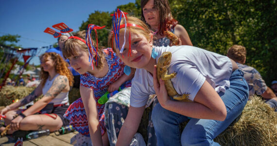 Photo by David Welton
A girl with a lizard fit right in the Fourth of July parade and celebration at Maxwelton. The day was a celebration of all things Americana, with the usual eclectic collection of folks.