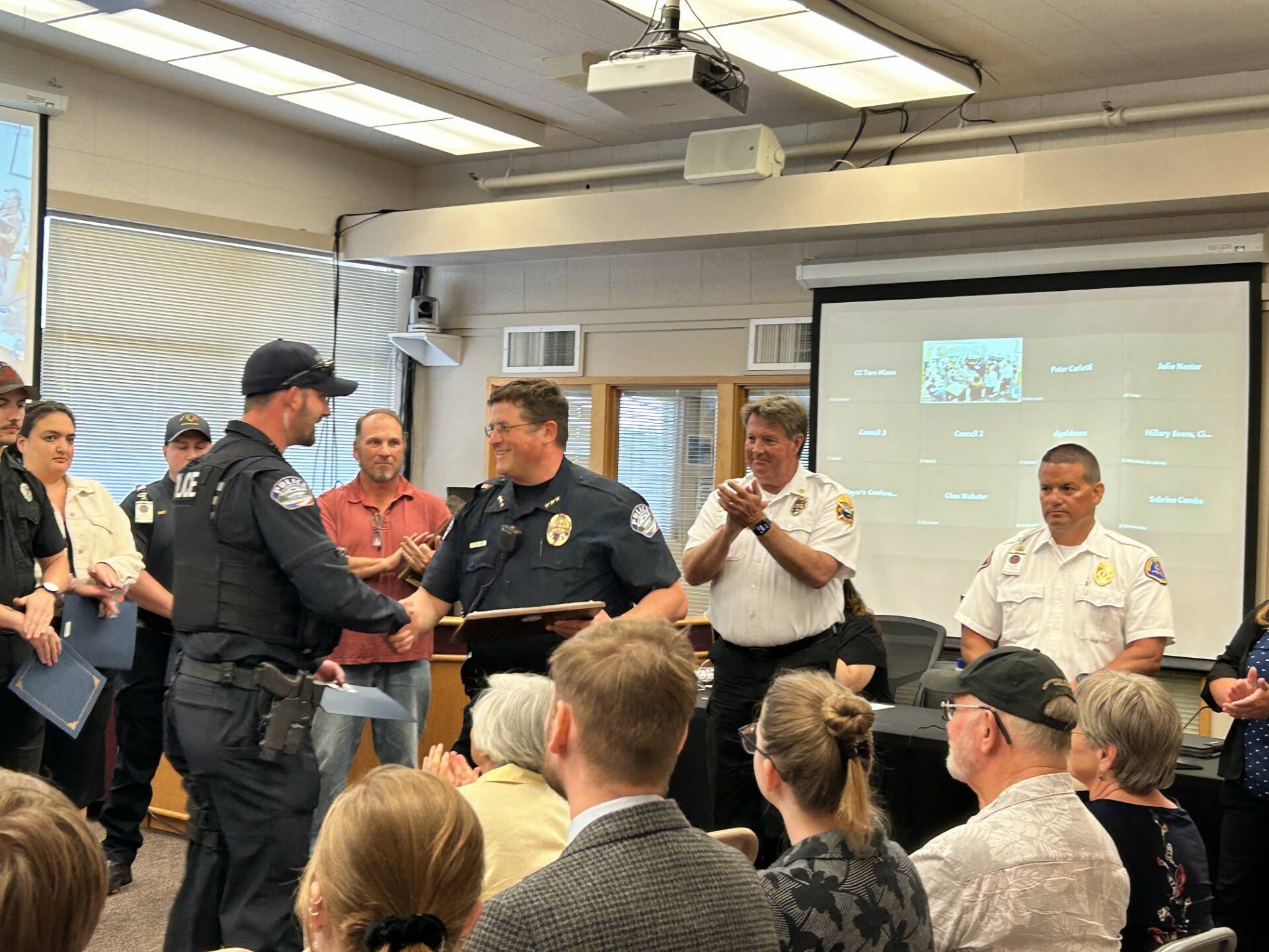 Police Chief Tony Slowik (right) provides a lifesaving award to Officer Jesse Caravan for his swift efforts during an overdose incident on May 10. (Photo provided)