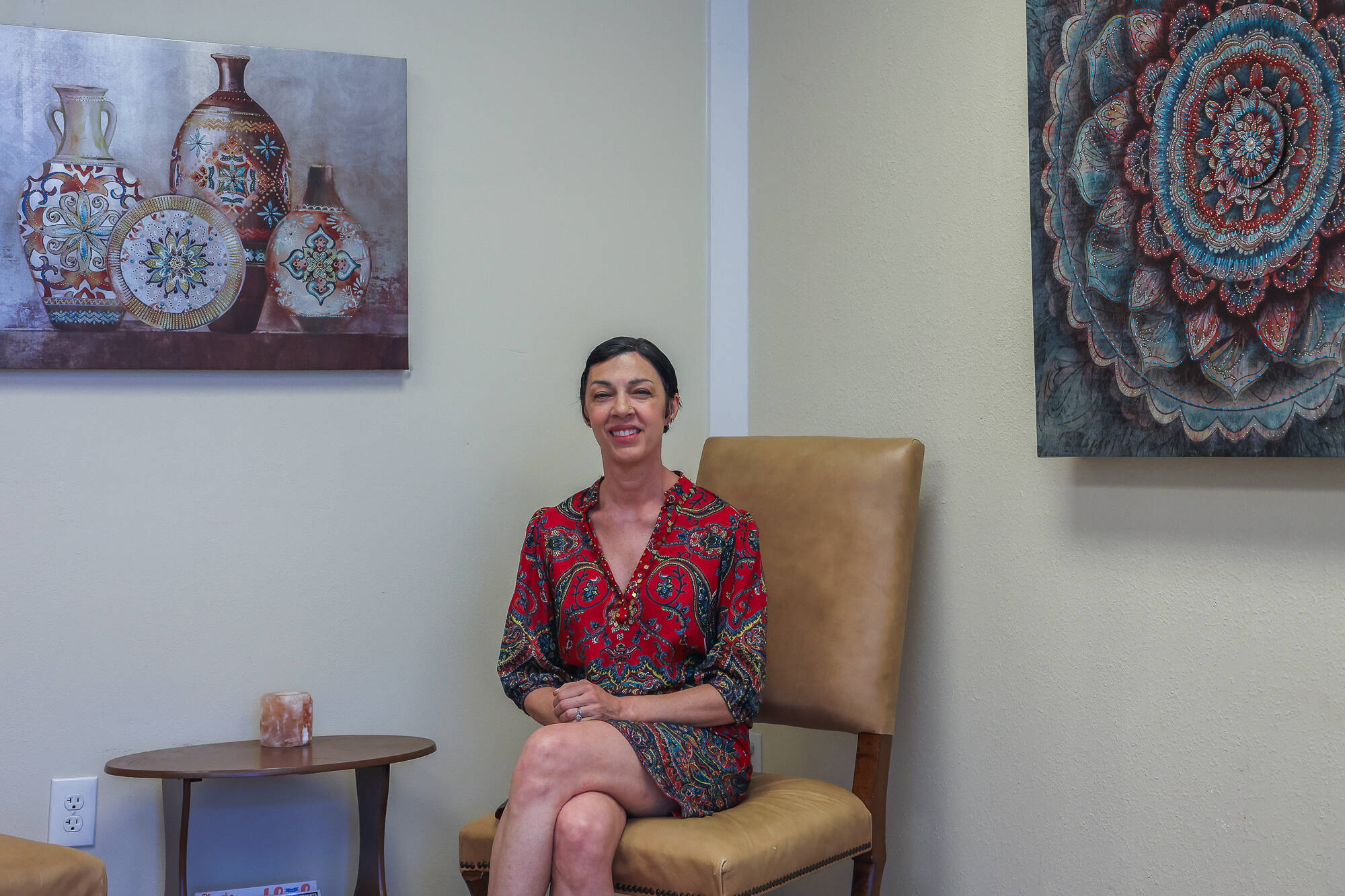 Hypnotherapist Jenna Alexander poses in a chair in her waiting room, July 8. (Photo by Caitlyn Anderson)