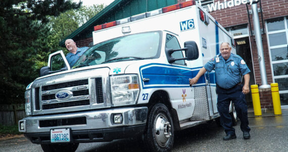 Photo by Sam Fletcher
Tom Cross, WhidbeyHealth paramedic, loads into an ambulance with his partner.