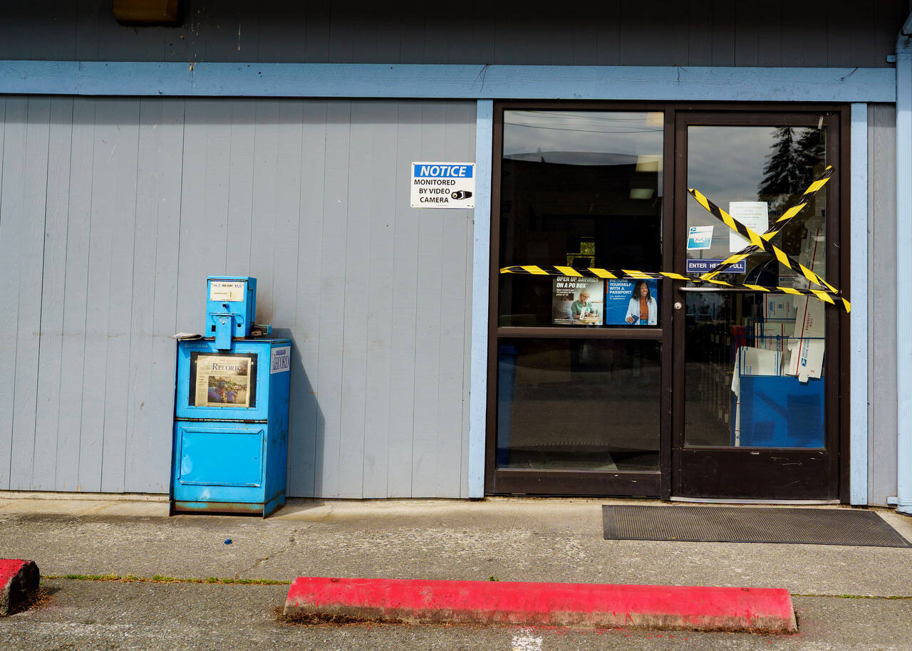 Police tape covered the door to the Clinton Post Office Wednesday. (Photo by David Welton)