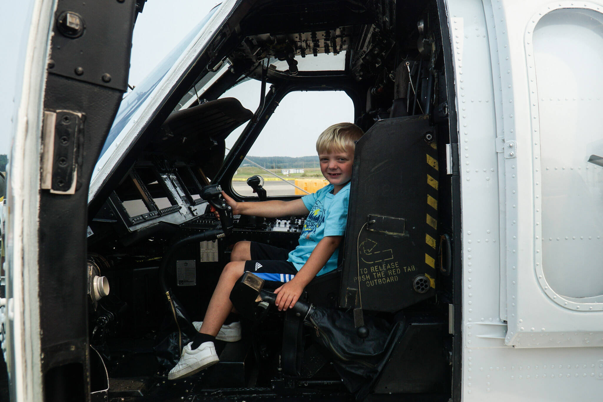 Archer Grimmes pilots the Search and Rescue helicopter at Naval Air Station Whidbey Island on Saturday. According to his grandpa, he may be a future pilot. (Photo by Sam Fletcher)