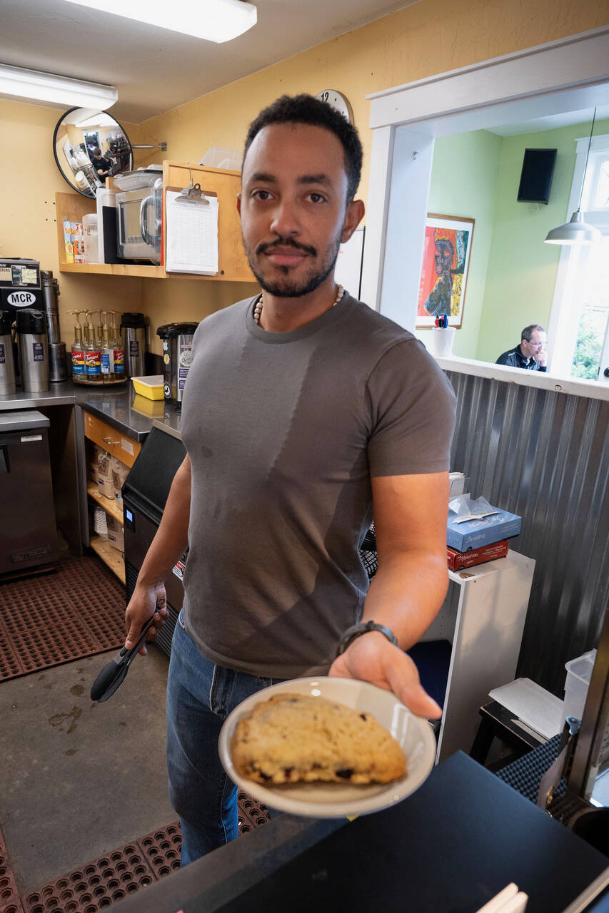 Davin McCullough serves a scone. (Photo by David Welton)