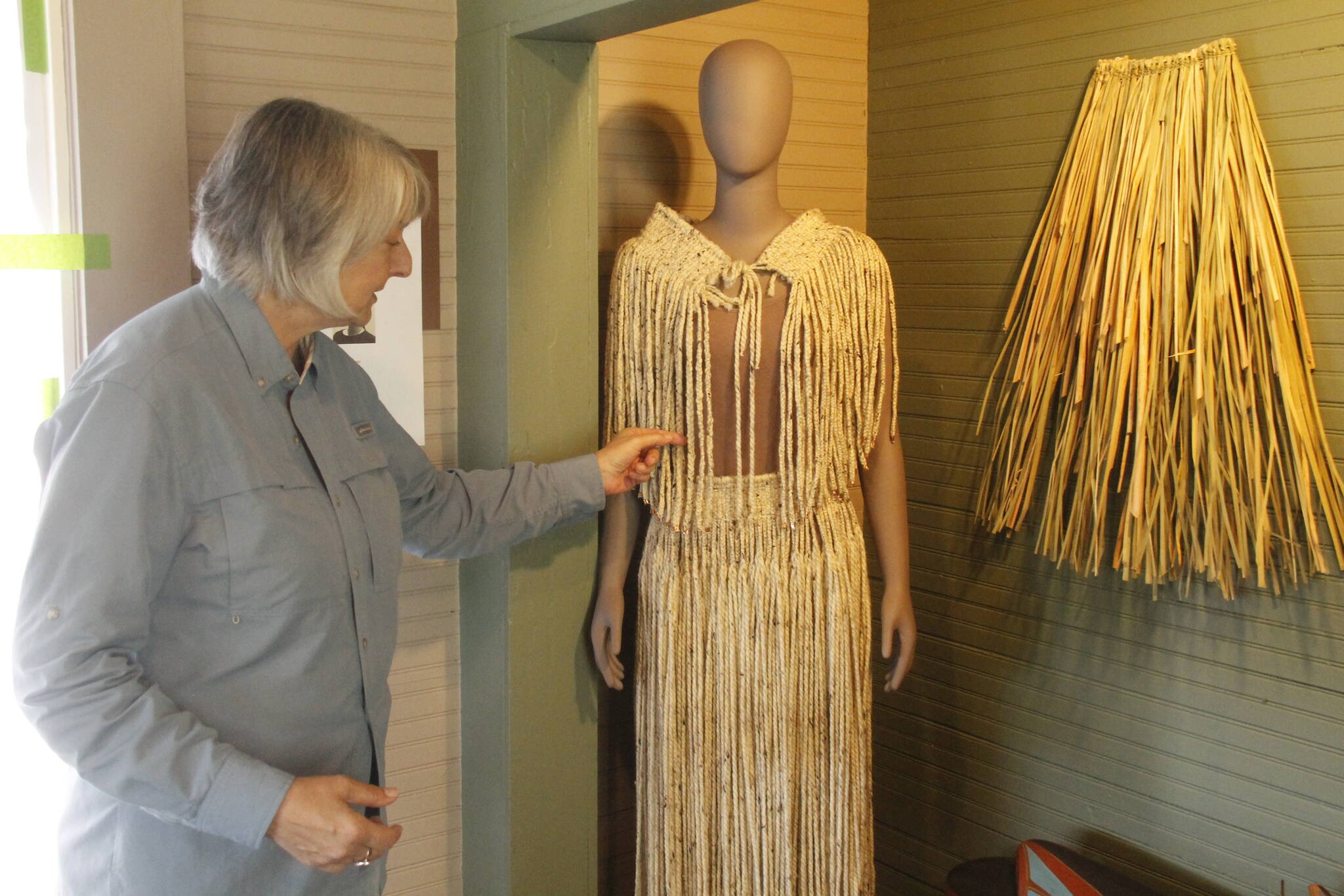 (Photo by Kira Erickson/South Whidbey Record)
Kyle Walker arranges a display of indigenous clothing made by Pamela SeaMonster of the Snohomish Tribe.