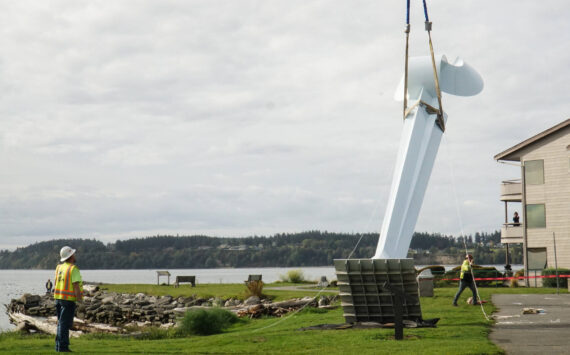 Ram Construction staff hoist the horizontal Angel De Creatividad sculpture upright on Wednesday. (Photo by Sam Fletcher)