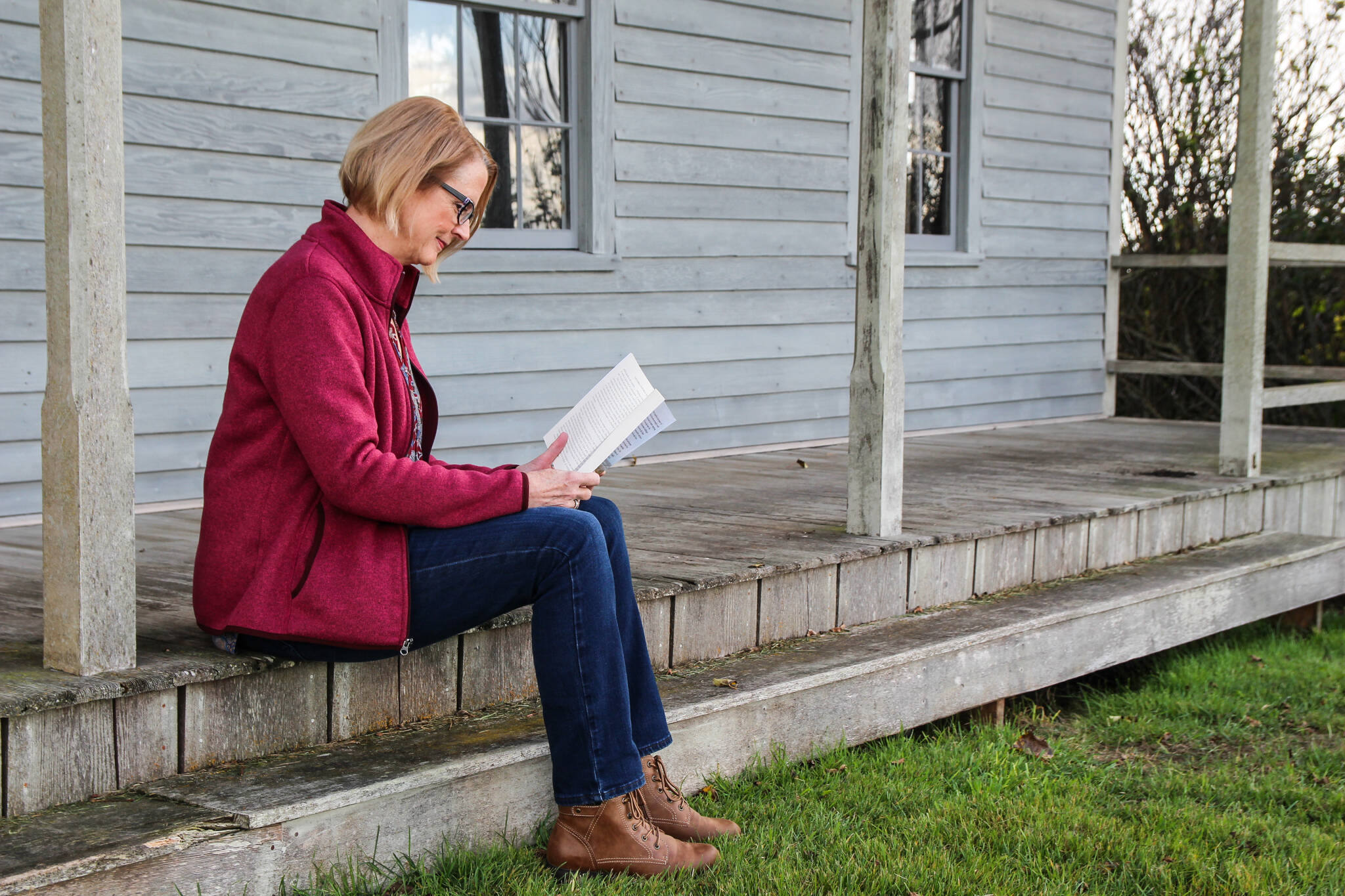 (Photo by Luisa Loi)
Shea reads her book on the porch of the house located near where Isaac Ebey’s home once stood.