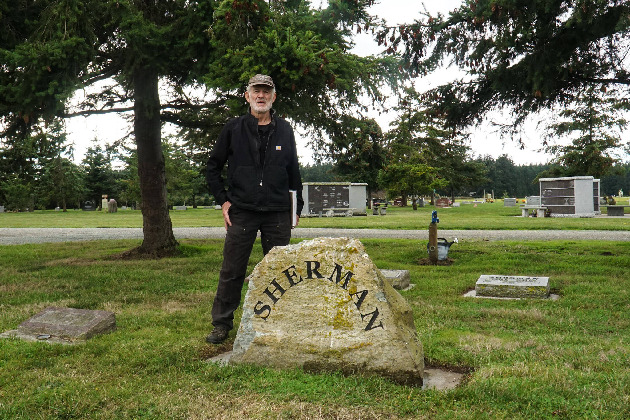 Vin Sherman stands by his family headstone at Sunnyside Cemetery. (Photo by Sam Fletcher)