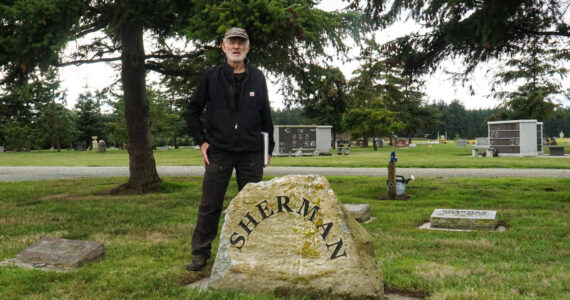 Vin Sherman stands by his family headstone at Sunnyside Cemetery. (Photo by Sam Fletcher)