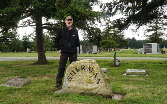 Vin Sherman stands by his family headstone at Sunnyside Cemetery. (Photo by Sam Fletcher)