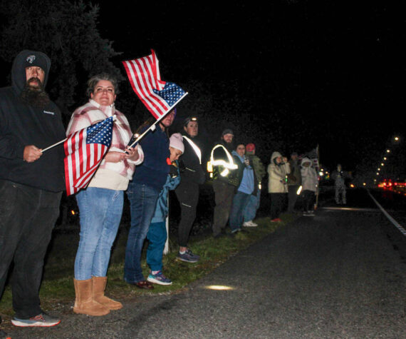 Photo by Sam Fletcher 
Members of the Oak Harbor community show support during the procession of Lt. Serena “Dug” Wileman on Monday.