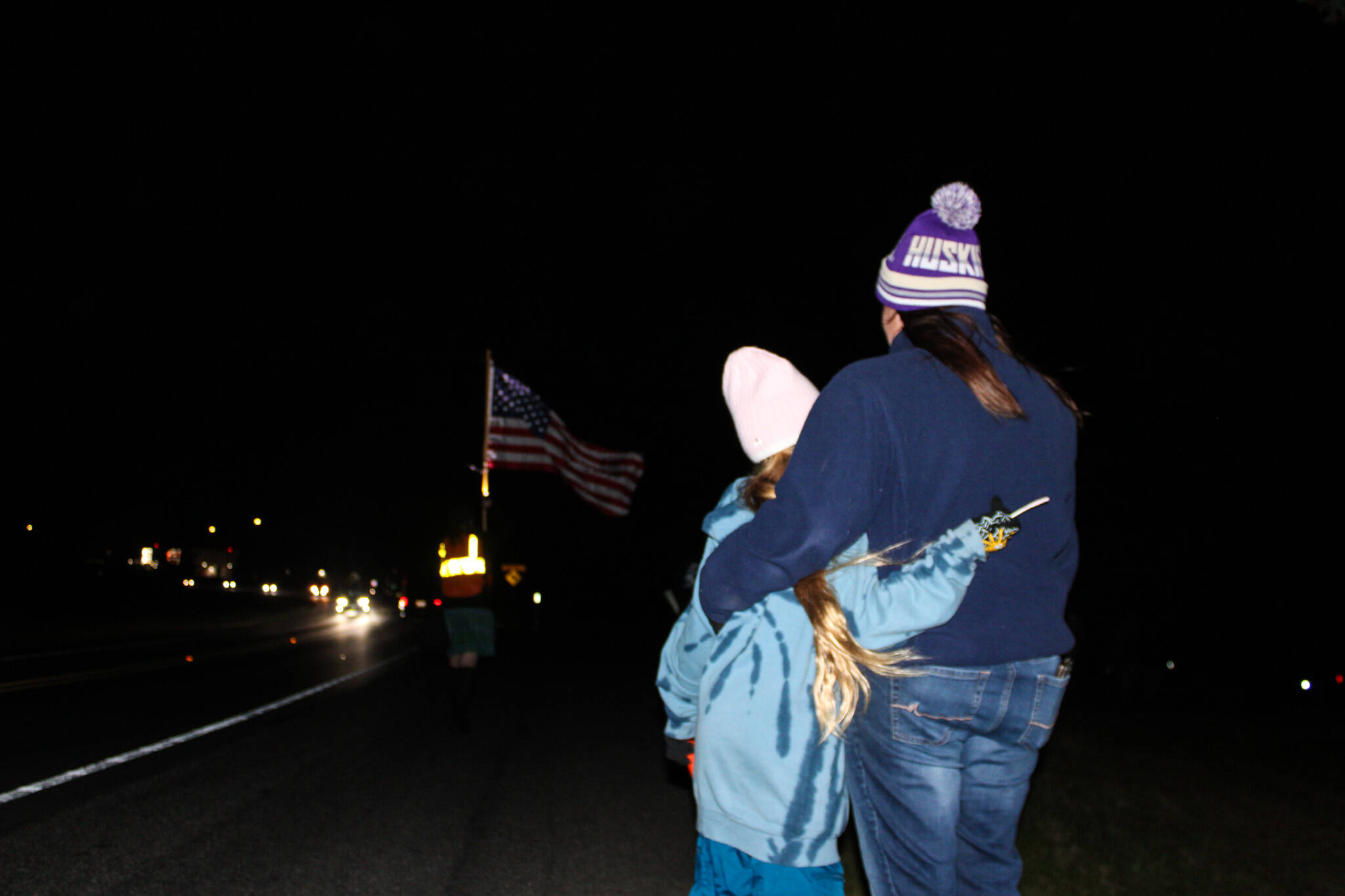 Amie Welden holds her daughter, Kailee, before the procession of Lt. Serena “Dug” Wileman, one of the two aviators lost in the Oct. 15 EA-18G Growler crash during routine training near Mount Rainier, as she returned home from Dover Air Force Base on Monday. (Photo by Sam Fletcher)