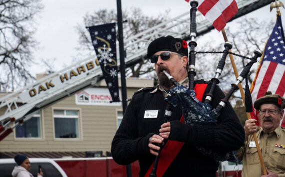 Don Scoby, commander of Scottish American Military Society Pig War Post 1859, plays the bagpipe at the Veteran's Day Parade in Oak Harbor. (Photo by Sam Fletcher)