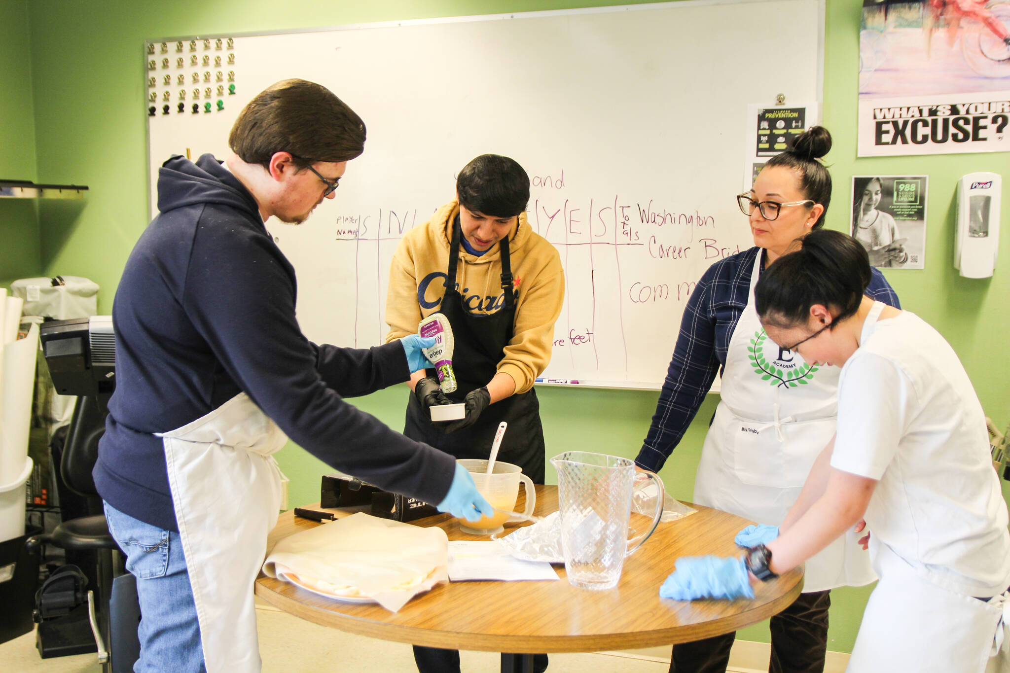 (Photo by Luisa Loi)
At left, Aaron Bates, Andy Angeles, Career Coach Cristina Frisby and Zoe Castillo prepare deviled eggs.