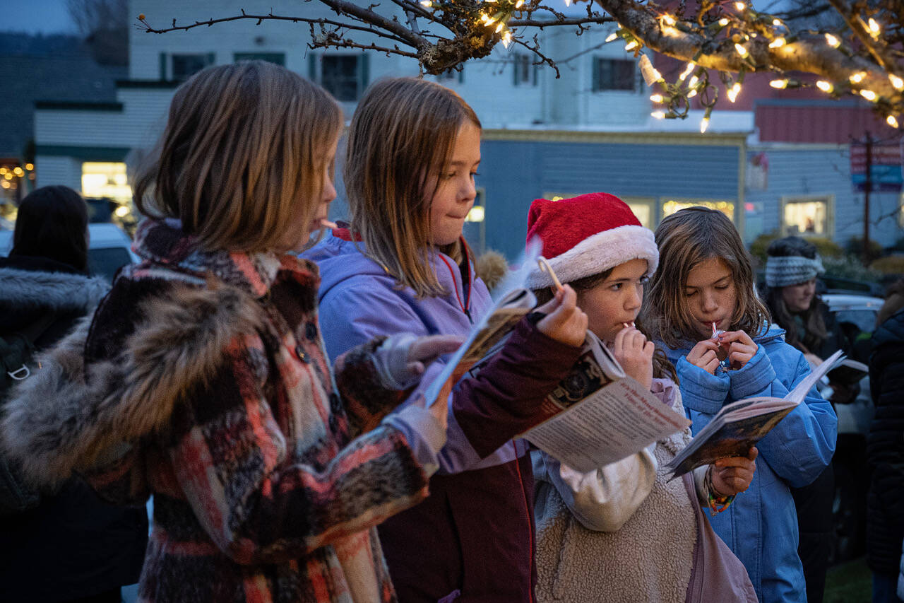 (Photo by David Welton)
With candy canes in hand, kids sing Christmas carols.