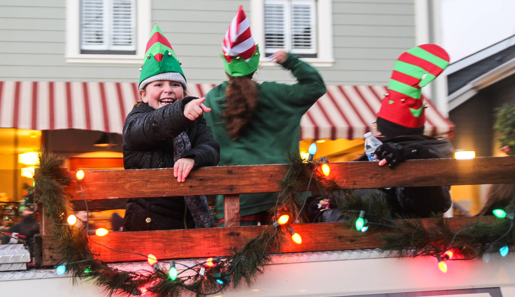 A rogue elf on Callen’s Christmas float throws candy at the crowd during a Christmas parade in Coupeville Saturday.