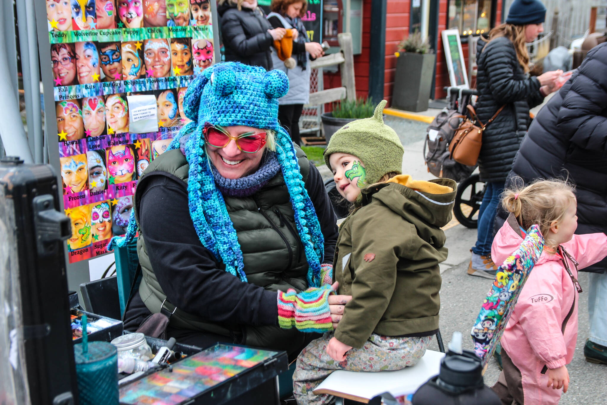 Photo by Luisa Loi
A child admires the work of a skilled face painter at the 2024 Penn Cove Musselfest.