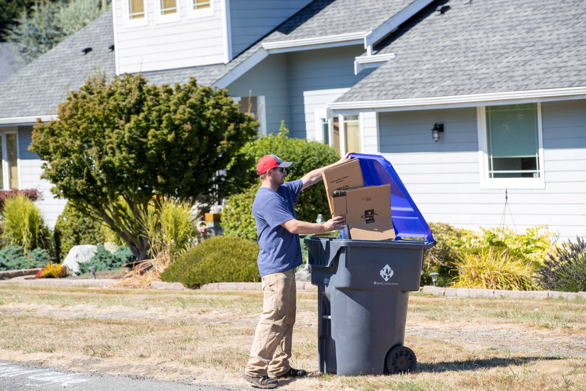 (Photo provided)
James Andersen fills an Island Disposal recycling container.