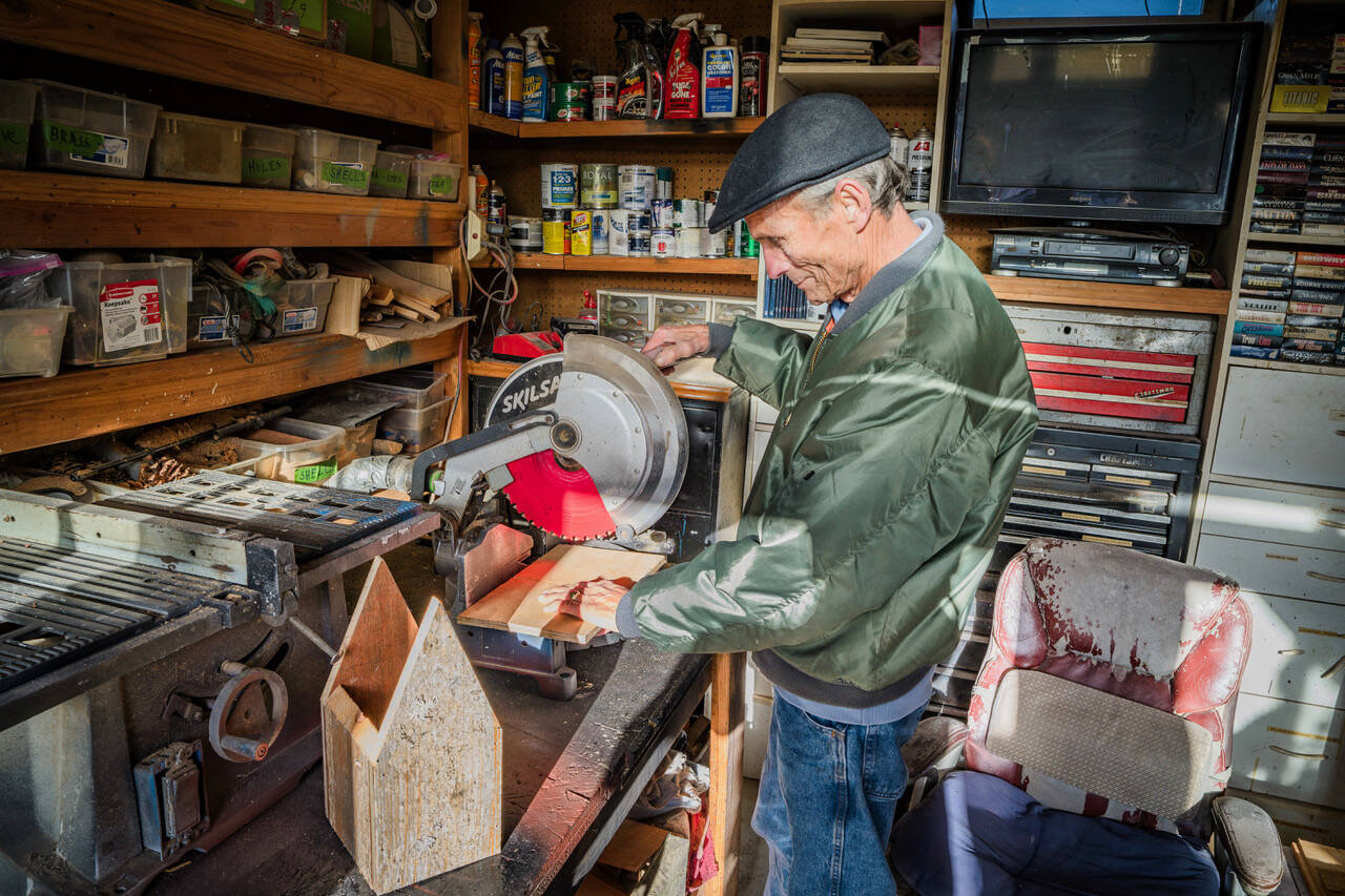 (Photo by David Welton)
John Schmidt constructs the roof for a birdhouse in his workshop.