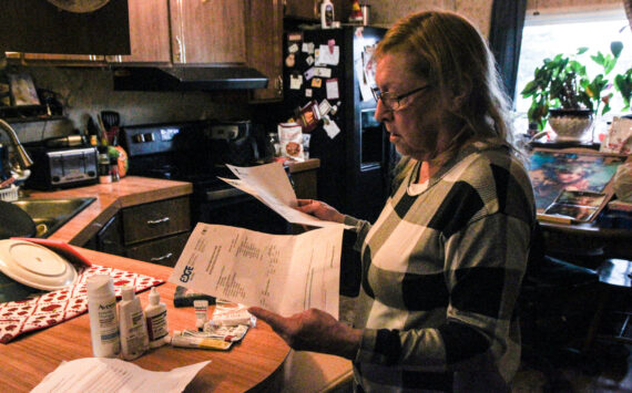 Denis Muller, a resident of Parkwood Manor Mobile Home Park, revies water testing results from Edge Analytical Laboratories. (Photo by Sam Fletcher)