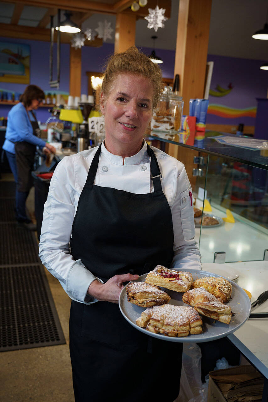 (Photo by David Welton)
Julie Parrick holds a tray of pastries, from apple bear paws to coconut mango scones to raspberry Danishes.